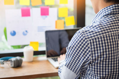 Midsection of man working at home