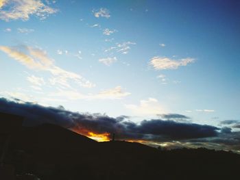 Low angle view of silhouette mountain against sky during sunset