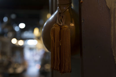 Close-up of decoration hanging by wall at night