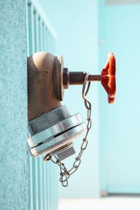 Close-up of telephone pole against wall