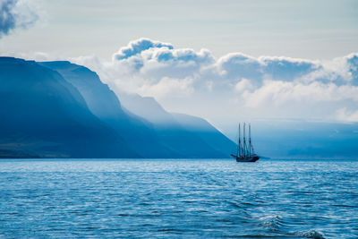 Sailboat sailing on sea against sky