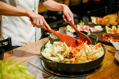 Midsection of man preparing food on table