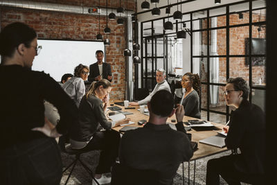 Multi-ethnic business professional planning strategy in board room