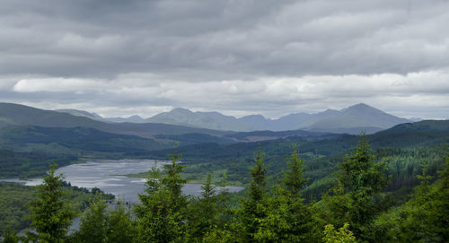 Scenic view of mountains against cloudy sky