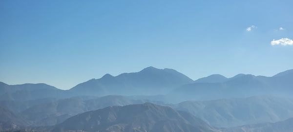 Scenic view of mountains against clear blue sky