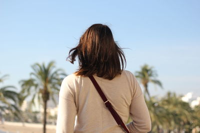 Rear view of woman looking up