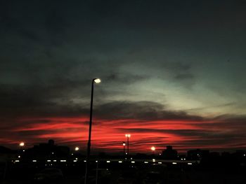 Street light against cloudy sky