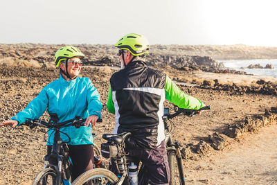 Senior couple with bicycles on land