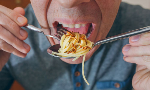 Midsection of man eating ice cream