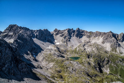 Scenic view of snowcapped mountains against clear blue sky