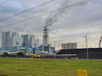 Modern buildings against cloudy sky