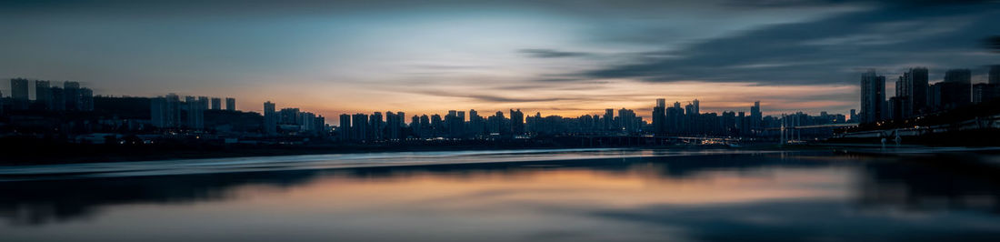 View of city at waterfront during sunset
