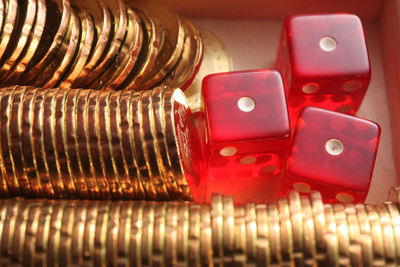 Close-up of coins with dice in container