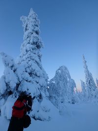 Person in snow against clear blue sky