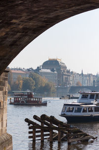 Boats in river with buildings in background