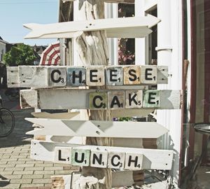 Close-up of road sign against buildings in city