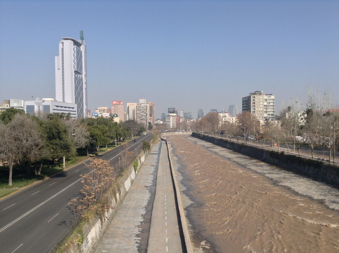 ROAD AMIDST BUILDINGS AGAINST SKY