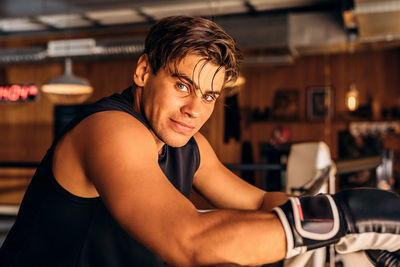 Portrait of confident boxer standing in health club