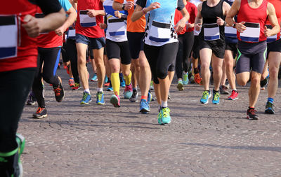 Low section of people running on road