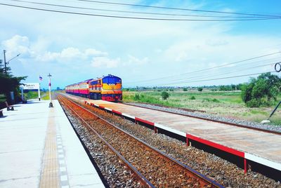 Train at railroad station against sky