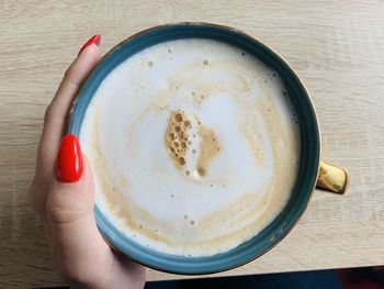 Close-up of hand holding coffee cup