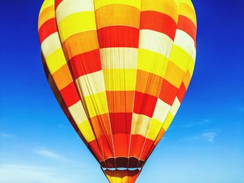 Low angle view of hot air balloon against blue sky