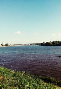 Scenic view of river against cloudy sky