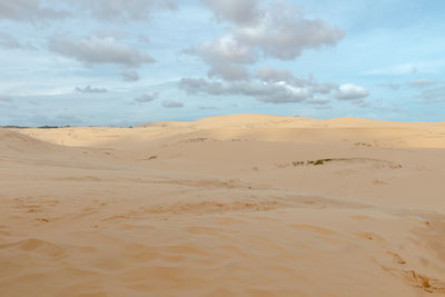 View of sand dunes against sky