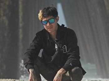 Young man wearing sunglasses standing outdoors