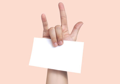 Close-up of human hand against white background