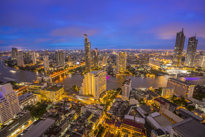 High angle view of illuminated buildings against sky at night