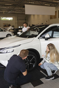 Customers in car dealership office