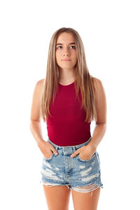 Portrait of teenage girl standing against white background