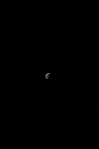 Low angle view of half moon against sky at night