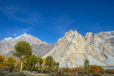 Scenic view of snowcapped mountains against blue sky