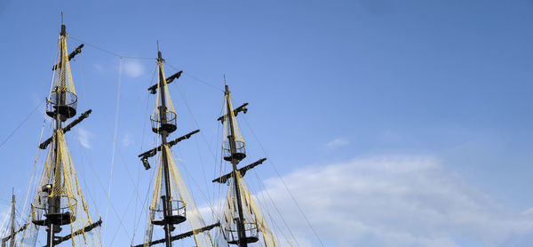 The masts of the ship on the background of the blue sky.  concept of travel and freedom. copy space
