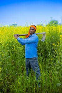 Portrait of man standing on field