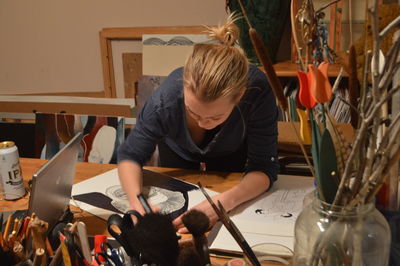 High angle view of woman painting on table