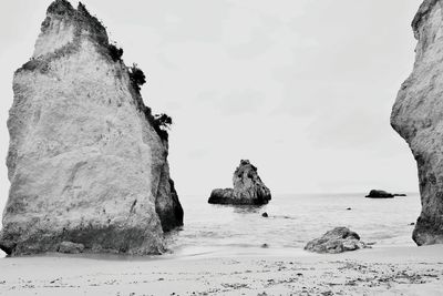 Panoramic view of rocks on beach against sky