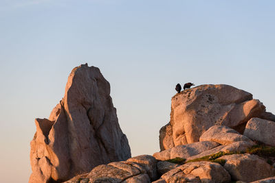 Low angle view of rock formation against sky