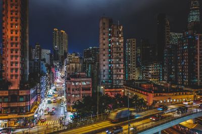 Illuminated cityscape against sky at night