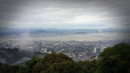 Cityscape against cloudy sky