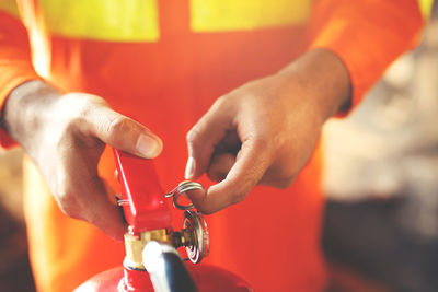 Cropped hands of man holding faucet