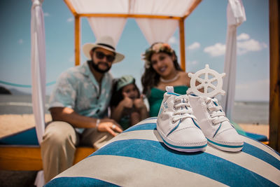 Close-up of shoes with family in background
