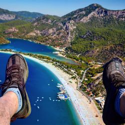 Low section of woman standing on cliff