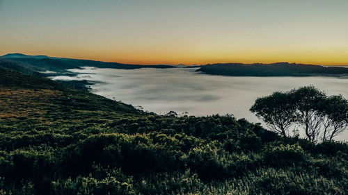 Scenic view of land against sky during sunset