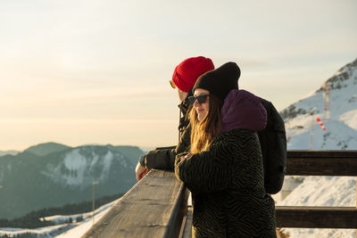 Couple enjoying winter sunny weather holiday ski resort outdoors. caucasian happy young people 