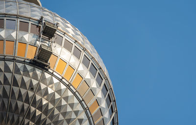 Low angle view of modern building against clear blue sky