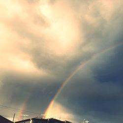 Low angle view of rainbow against sky during sunset