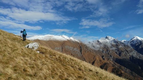 Men on mountain against sky